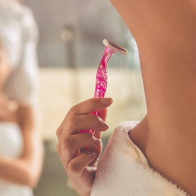 Beautiful,Young,Woman,In,Bath,Towel,Is,Shaving,Underarms,Using